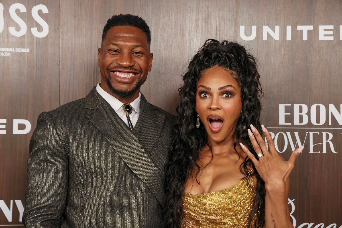 <i>Rodin Eckenroth/Getty Images via CNN Newsource</i><br/>Jonathan Majors smiles as Meagan Good flashes her engagement ring at the 2024 EBONY Power 100 Gala at Nya Studios in Los Angeles on November 17. Jonathan Majors and Meagan Good have announced their engagement at the same annual event where they met two years ago.