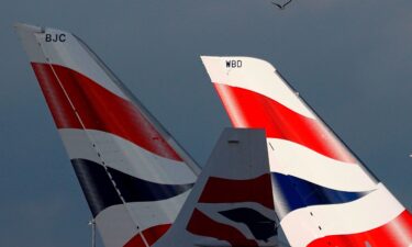 Sunlight illuminates the tailfins of British Airways aircraft at Terminal 5 of London Heathrow Airport on February 5