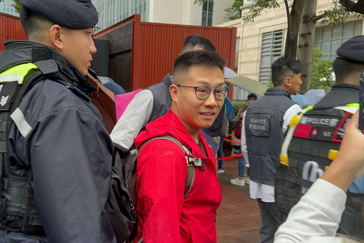 <i>Chris Lau/CNN via CNN Newsource</i><br/>Police pull prominent activists from the queue to conduct search