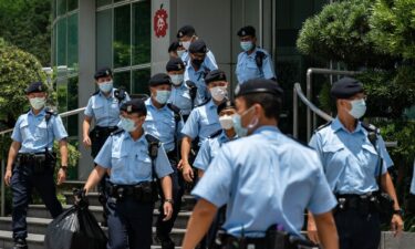 Police carry evidence they sized from the headquarters of the Apple Daily newspaper on June 17