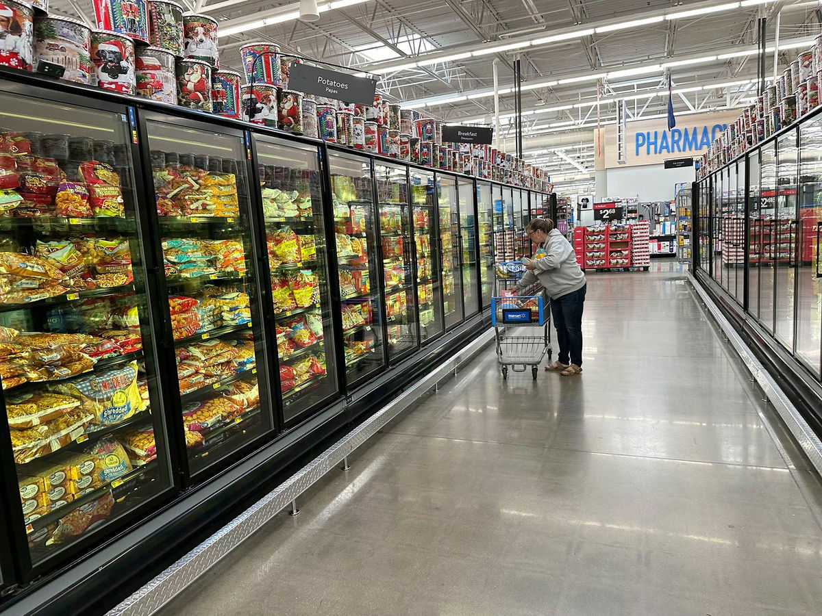 <i>David Zalubowski/AP via CNN Newsource</i><br/>A lone shopper places items in her cart in the frozen food aisle of a Walmart store on November 14