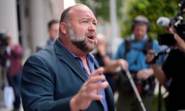 Right-wing conspiracy theorist Alex Jones speaks to the media after arriving at the federal courthouse in Houston on June 14.