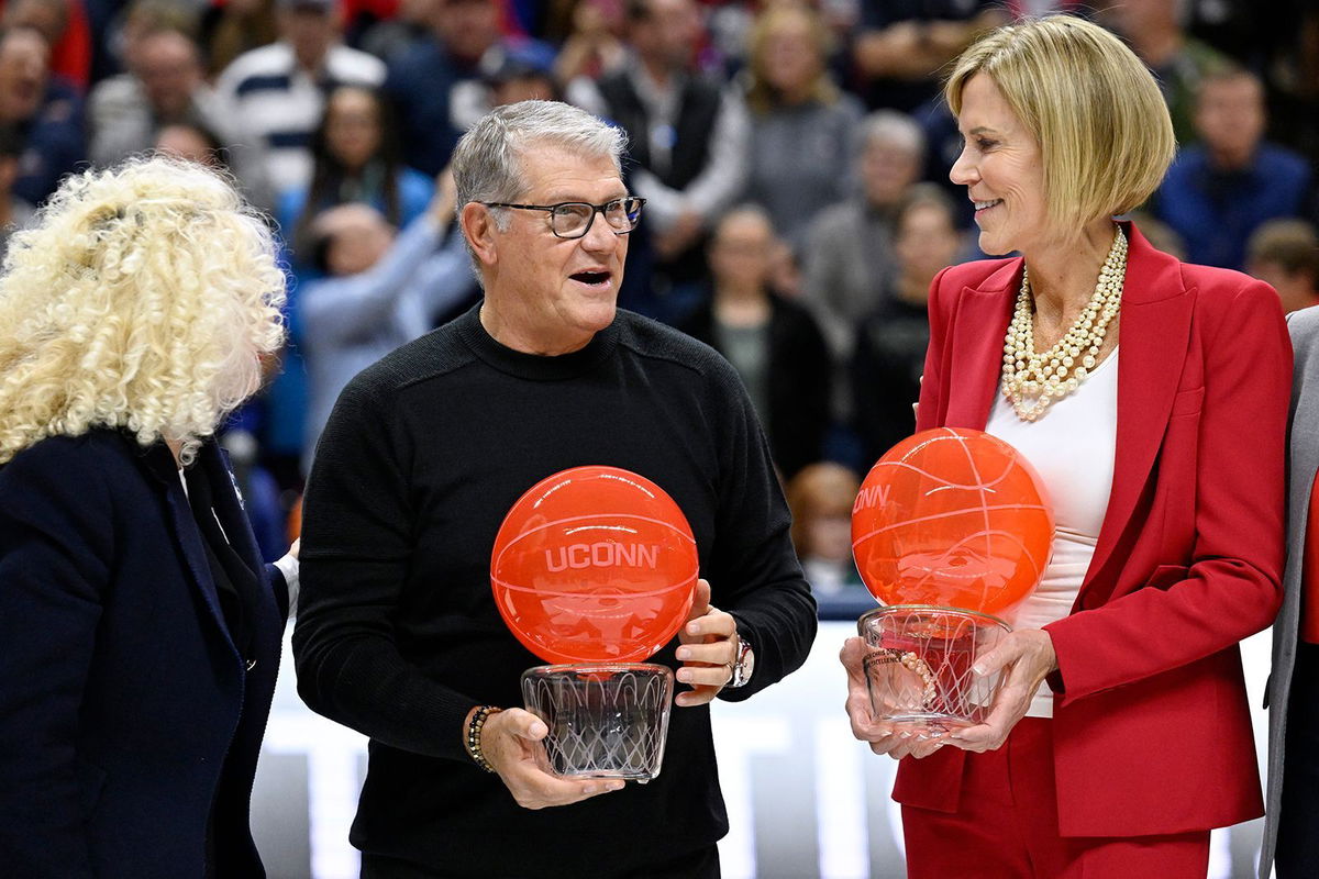 <i>Jessica Hill/AP via CNN Newsource</i><br/>UConn head coach Geno Auriemma and associate head coach Chris Dailey honored before the game on November 20.