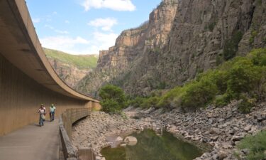 Bike riders pedal past a section of the Colorado River east of Glenwood Springs