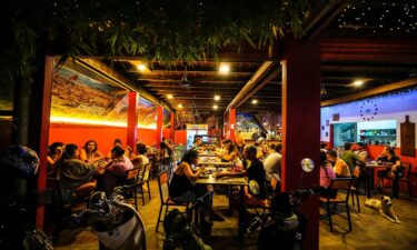 Tourists eat dinner at a hostel in Vang Vieng