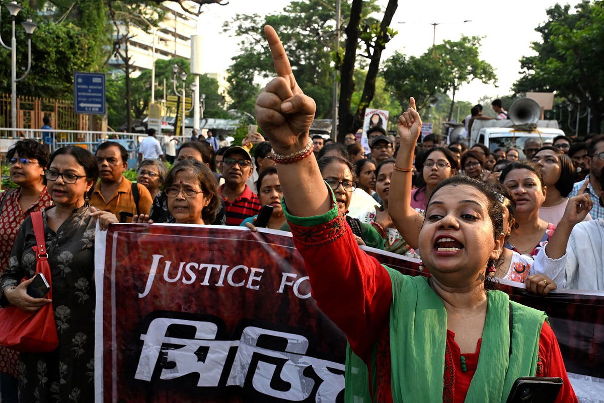 <i>Dibyangshu Sarkar/AFP/Getty Images via CNN Newsource</i><br/>Activists and medical professionals shout slogans as they take part in a protest march to condemn the rape and murder of a doctor in Kolkata on September 20.