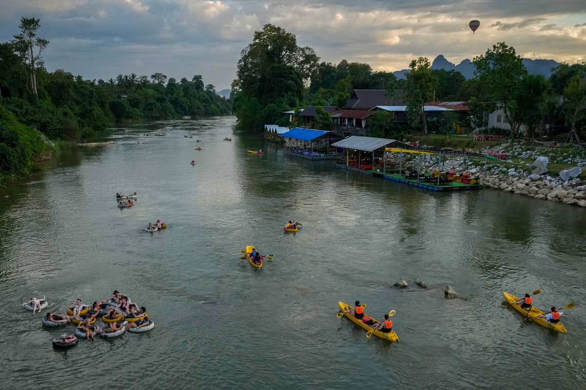 <i>Anupam Nath/AP via CNN Newsource</i><br/>Foreign tourists kayaking and tubing on the Song River in Vang Vieng