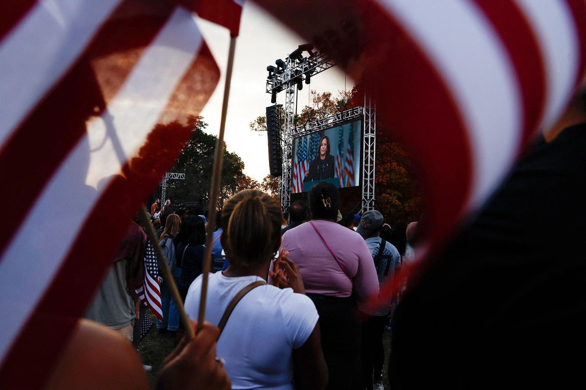 <i>Evelyn Hockstein/Reuters via CNN Newsource</i><br/>Supporters of Democratic presidential nominee Vice President Kamala Harris listen as she is seen in a screen delivering remarks