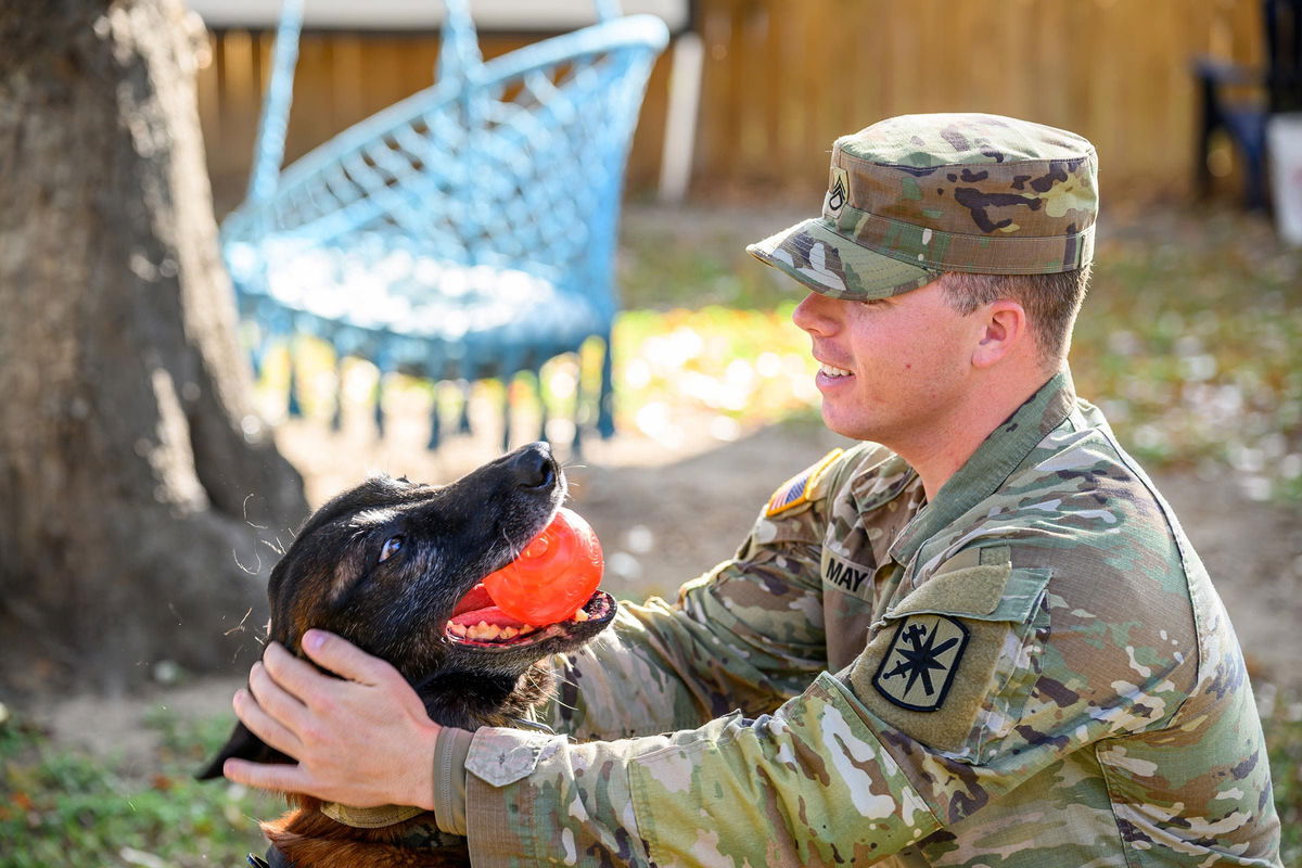 <i>Chris Saucedo/Getty Images via CNN Newsource</i><br/>May reunites Monday with his retiring military working dog