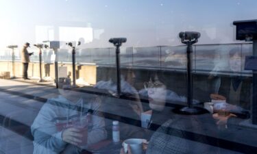 Customers inside the Starbucks coffee shop with views of North Korea on November 29.