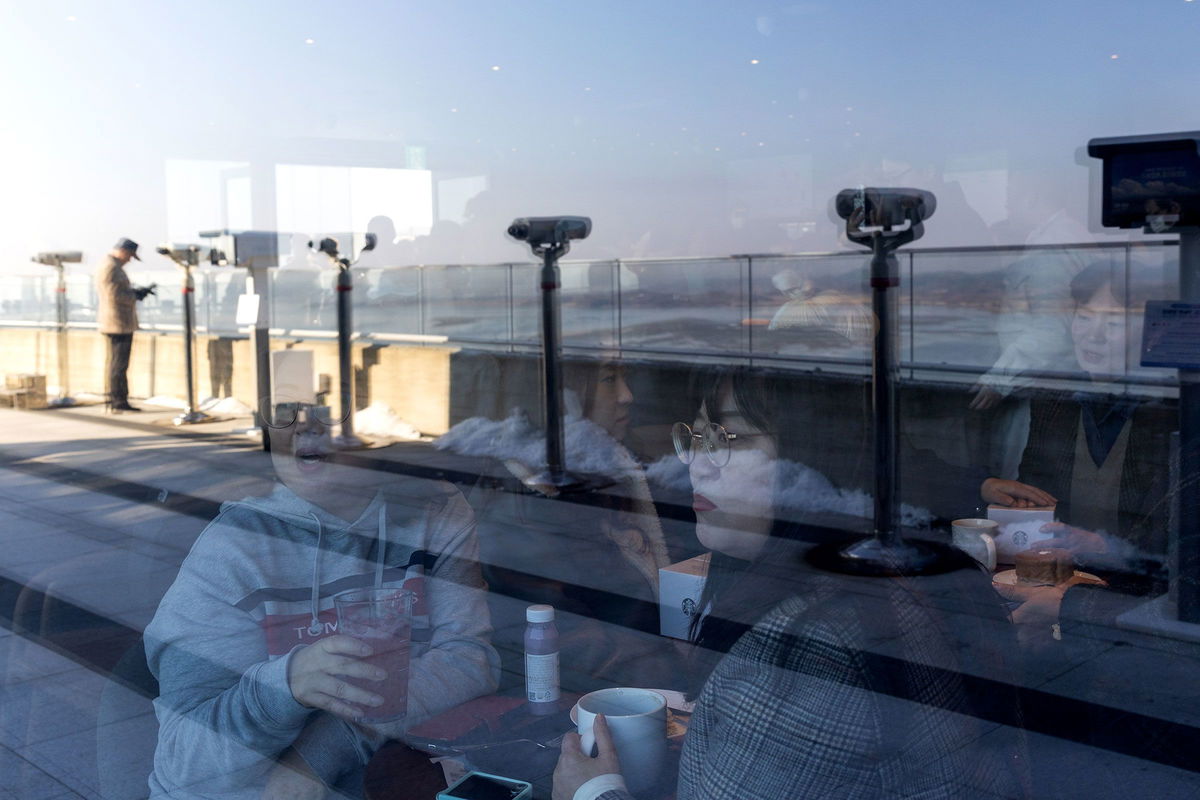 <i>SeongJoon Cho/Bloomberg/Getty Images via CNN Newsource</i><br/>Customers inside the Starbucks coffee shop with views of North Korea on November 29.