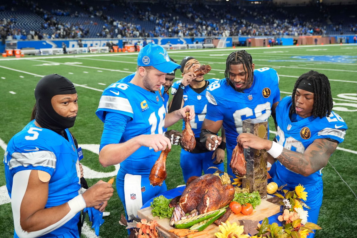 <i>Carlos Osorio/AP via CNN Newsource</i><br/>Lions players celebrate beating the Bears by eating turkey with David Montgomery (left) munching on a carrot.