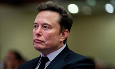 Elon Musk listens as President-elect Donald Trump speaks during a meeting with House Republicans at the Hyatt Regency hotel in Washington on November 13.