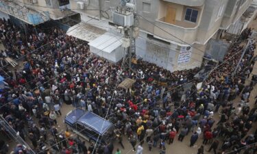 Hundreds of Palestinians gather to buy bread from a bakery in Deir al-Balah