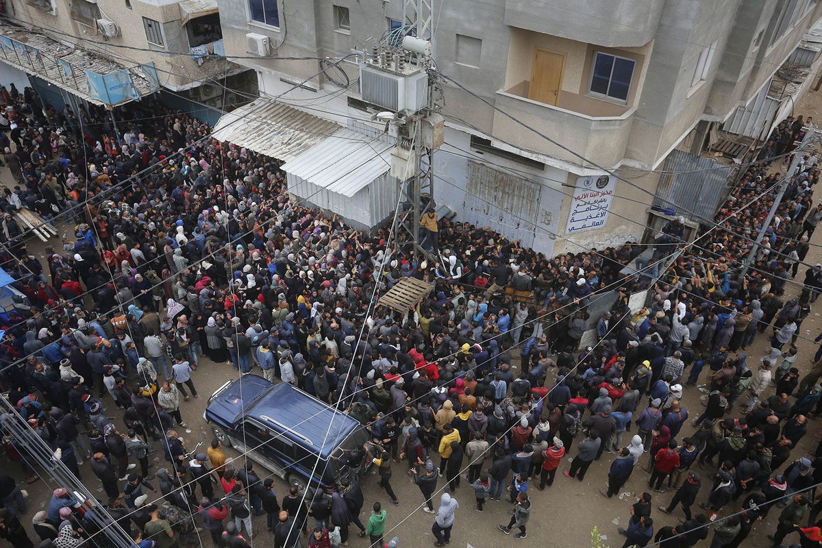 <i>Ashraf Amra/Anadolu/Getty Images via CNN Newsource</i><br/>Hundreds of Palestinians gather to buy bread from a bakery in Deir al-Balah