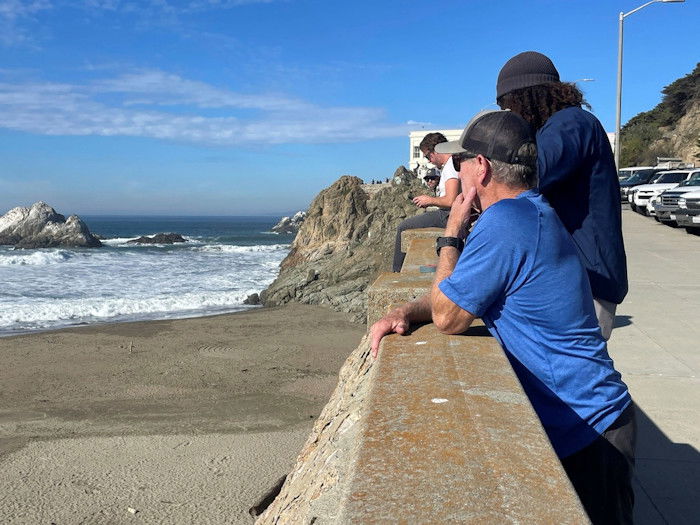 People watch the waves come in after an earthquake was felt widely across Northern California at Ocean Beach in San Francisco, Thursday, Dec. 5, 2024.