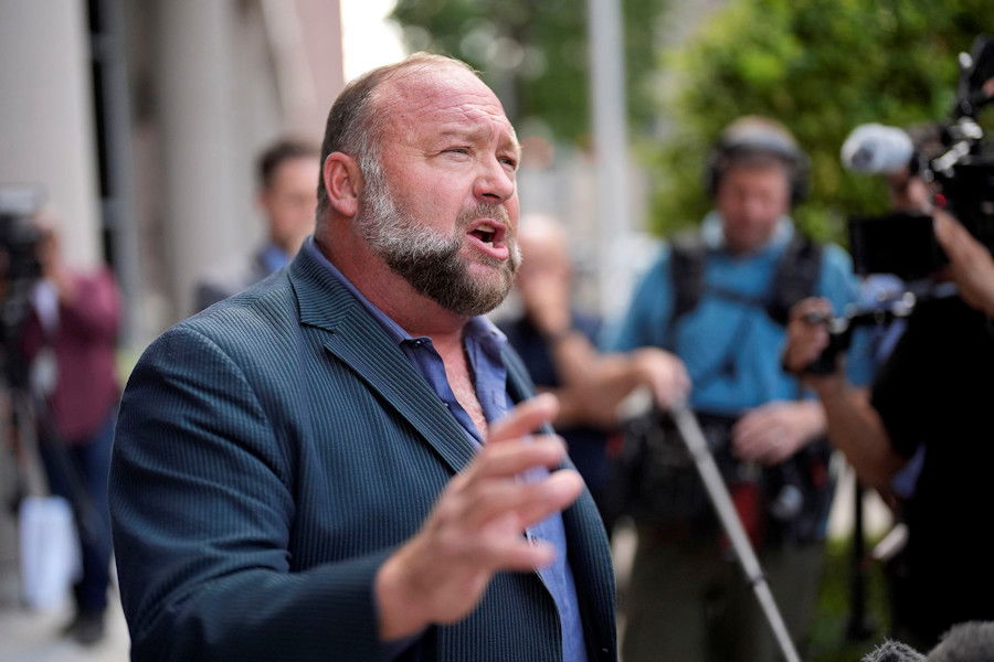 Right-wing conspiracy theorist Alex Jones speaks to the media after arriving at the federal courthouse for a hearing in front of a bankruptcy judge on June 14 in Houston. A judge has blocked The Onion’s winning bid for Jones’ Infowars.
