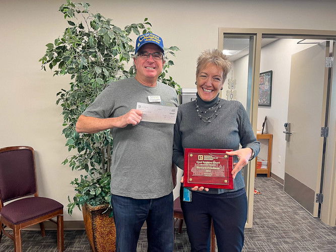 Commercial real estate broker Howard Friedman presents $2,500 check to Gwenn Wysling, executive director of the Bethlehem Inn.