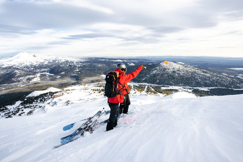 Mt. Bachelor Pro Patrol conducting avalanche mitigation work amid scenic views.