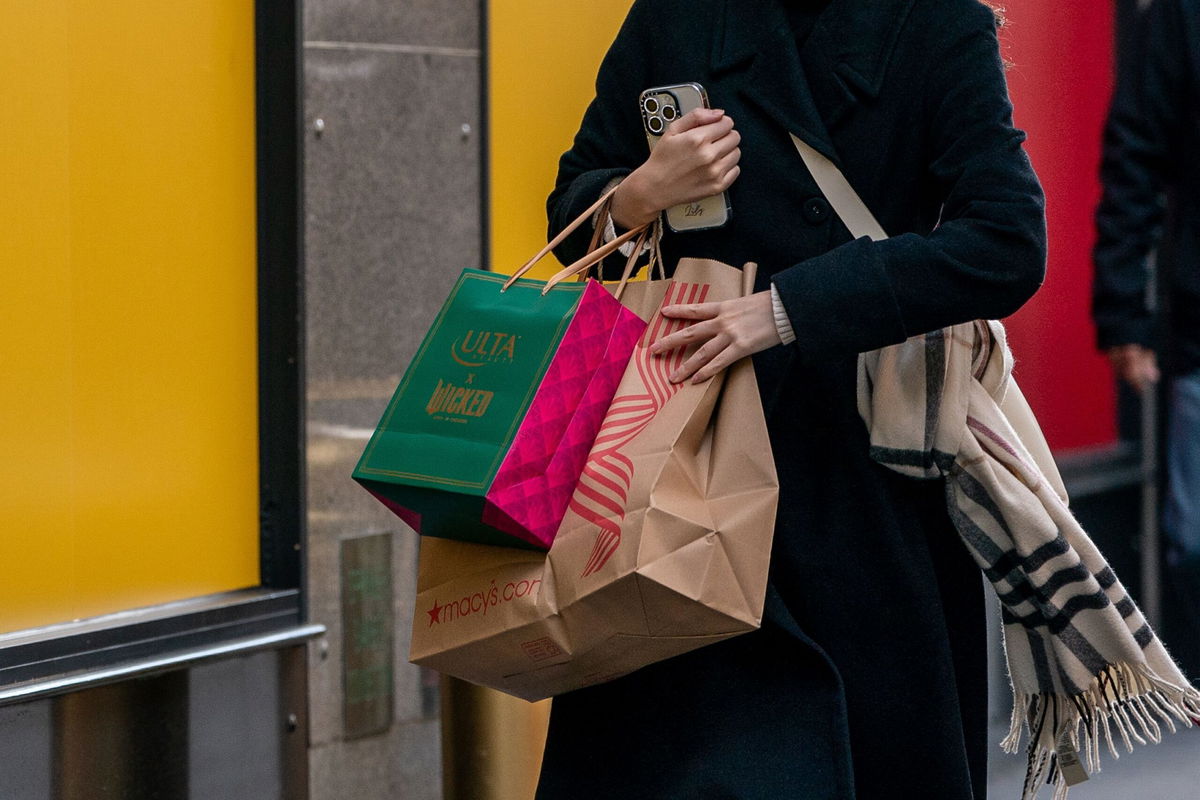 <i>David Dee Delgado/Getty Images via CNN Newsource</i><br/>A person walks down a street with shopping bags on November 29 in New York City. Despite retailers offering holiday discounts earlier than usual this year