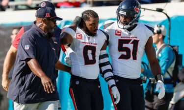 Houston Texans linebacker Azeez Al-Shaair (No. 0) was escorted off the field after being ejected from Sunday's game against the Jacksonville Jaguars