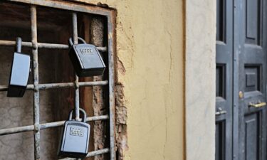 Key boxes protected by a numerical code hang outside an apartment door in Rome's Trastevere district.