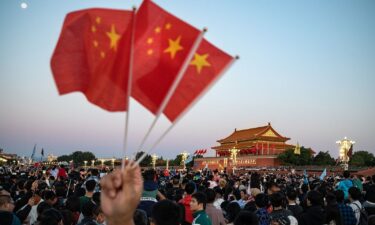 Visitors gather for the flag raising ceremony at Tiananmen Square to mark National Day in Beijing on Sunday