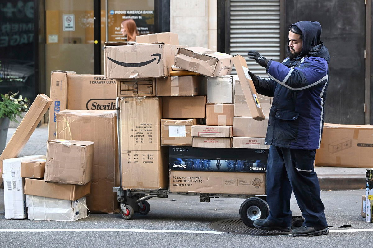 <i>Anthony Behar/Sipa USA/AP via CNN Newsource</i><br/>A Fedex worker sorts through packages set for delivery in Manhattan on December 2. Consumers spent a record $13.3 billion on Cyber Monday