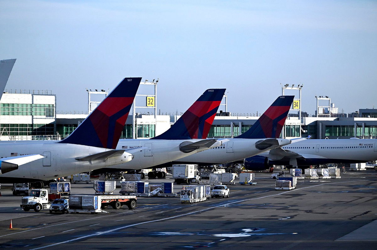 <i>Anthony Behar/Sipa USA/AP via CNN Newsource</i><br/>Delta Air Lines planes at their terminal in New York's John F. Kennedy International Airport.