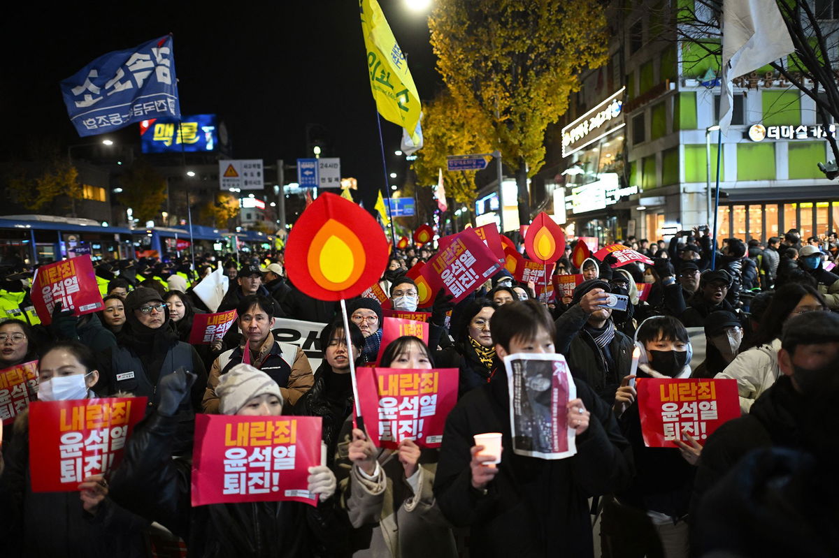 <i>Philip Fong/AFP/Getty Images via CNN Newsource</i><br/>Protesters taking part in a march against South Korea President Yoon Suk Yeol head toward the Presidential Office in Seoul on Wednesday