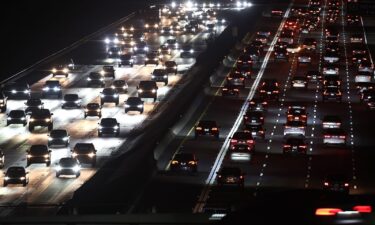 Motorists drive cars and other vehicles during the late afternoon commute on December 16 in Los Angeles.