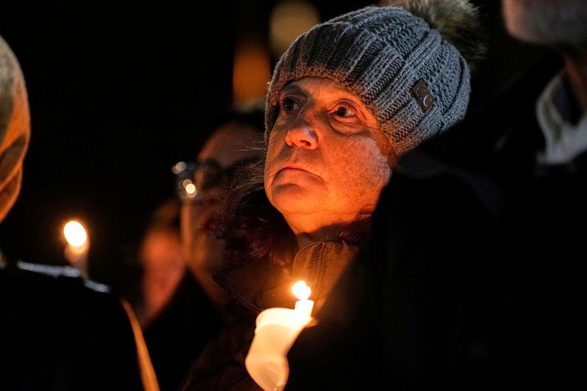 <i>Morry Gash/AP via CNN Newsource</i><br/>Supporters hold candles during a candlelight vigil Tuesday