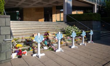 A makeshift memorial is set up on the steps of the Old National Bank