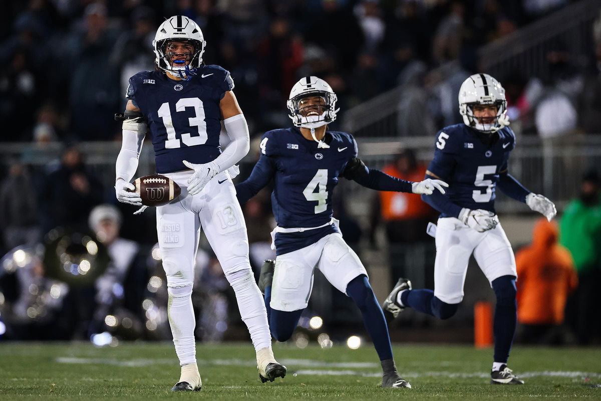 <i>Scott Taetsch/Getty Images via CNN Newsource</i><br/>Tony Rojas of the Penn State Nittany Lions celebrates with AJ Harris and Cam Miller after intercepting a pass against Maryland during the first half at Beaver Stadium on November 30 in Happy Valley.