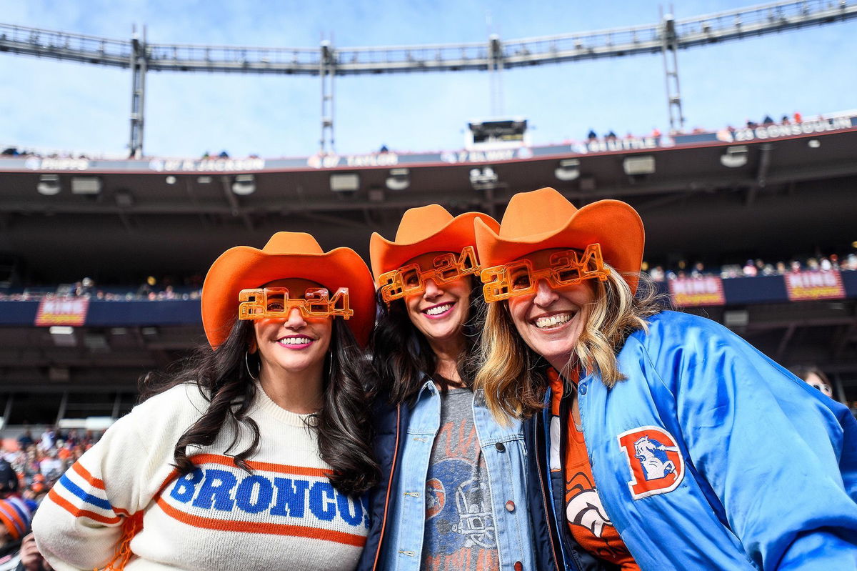 <i>Dustin Bradford/Getty Images via CNN Newsource</i><br/>Denver Broncos fans dressed with colorful costumes and New Years Eve flair as they watch a game between the Denver Broncos and the Los Angeles Chargers at Empower Field at Mile High on December 31