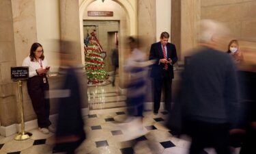 Members of the news media linger outside of the office of House Speaker Mike Johnson on Capitol Hill in Washington