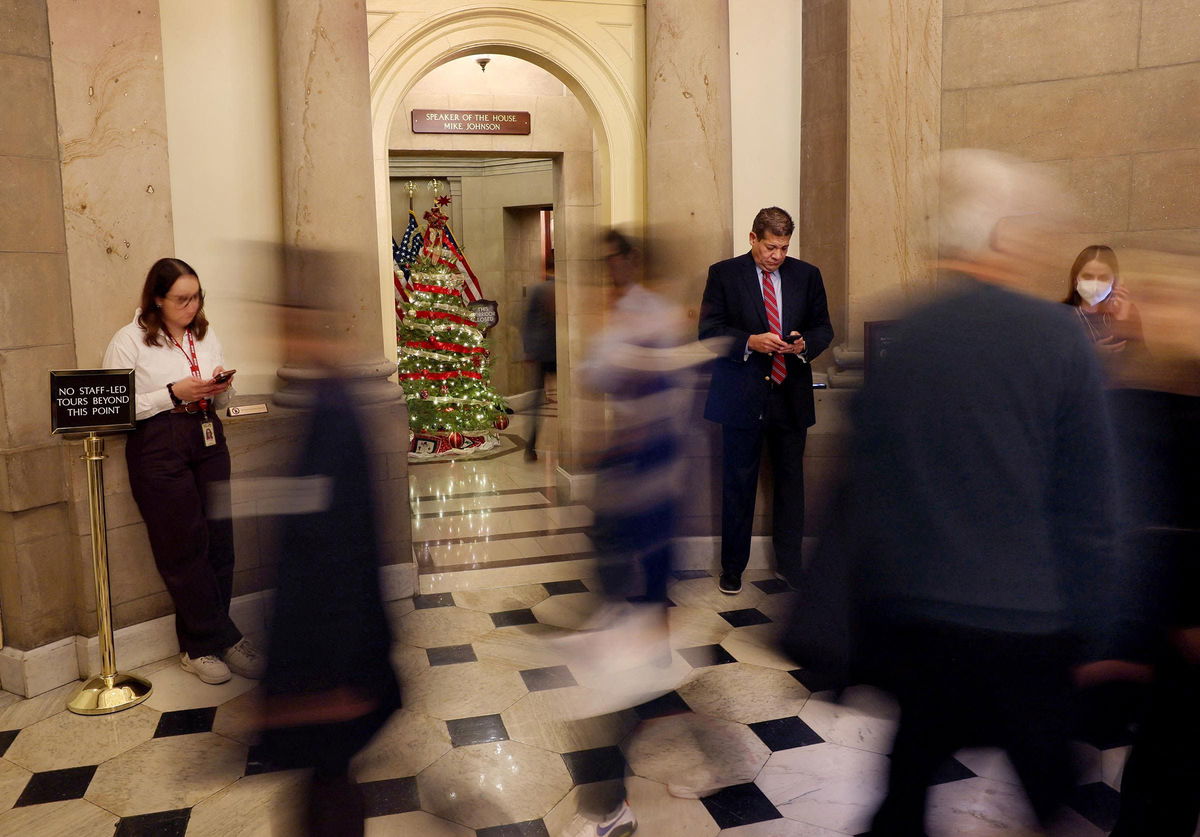 <i>Leah Millis/Reuters via CNN Newsource</i><br/>Members of the news media linger outside of the office of House Speaker Mike Johnson on Capitol Hill in Washington