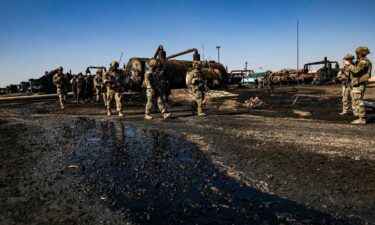 US soldiers inspect the site of reported Turkish shelling days earlier on an oil extraction facility on the outskirts of Rumaylan