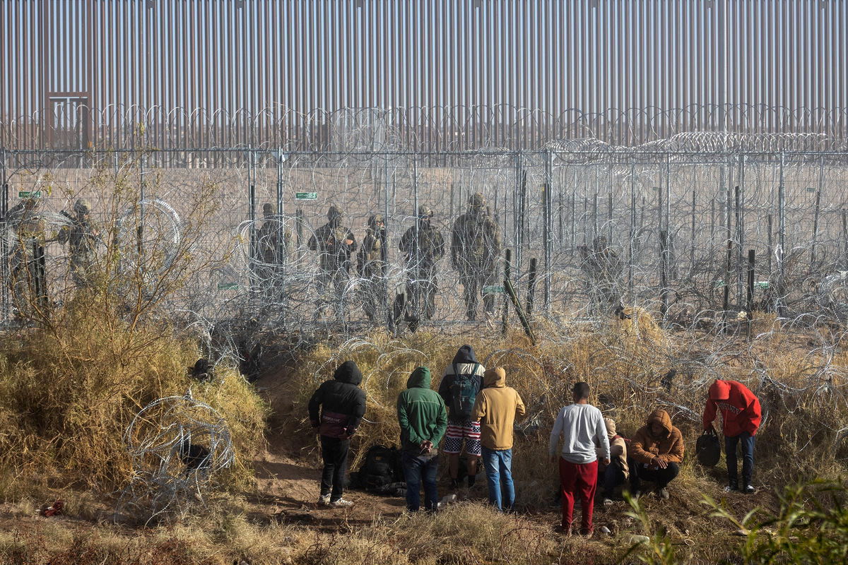 <i>David Peinado/Bloomberg/Getty Images via CNN Newsource</i><br/>Migrants near the Rio Grande along the US-Mexico border in Juarez