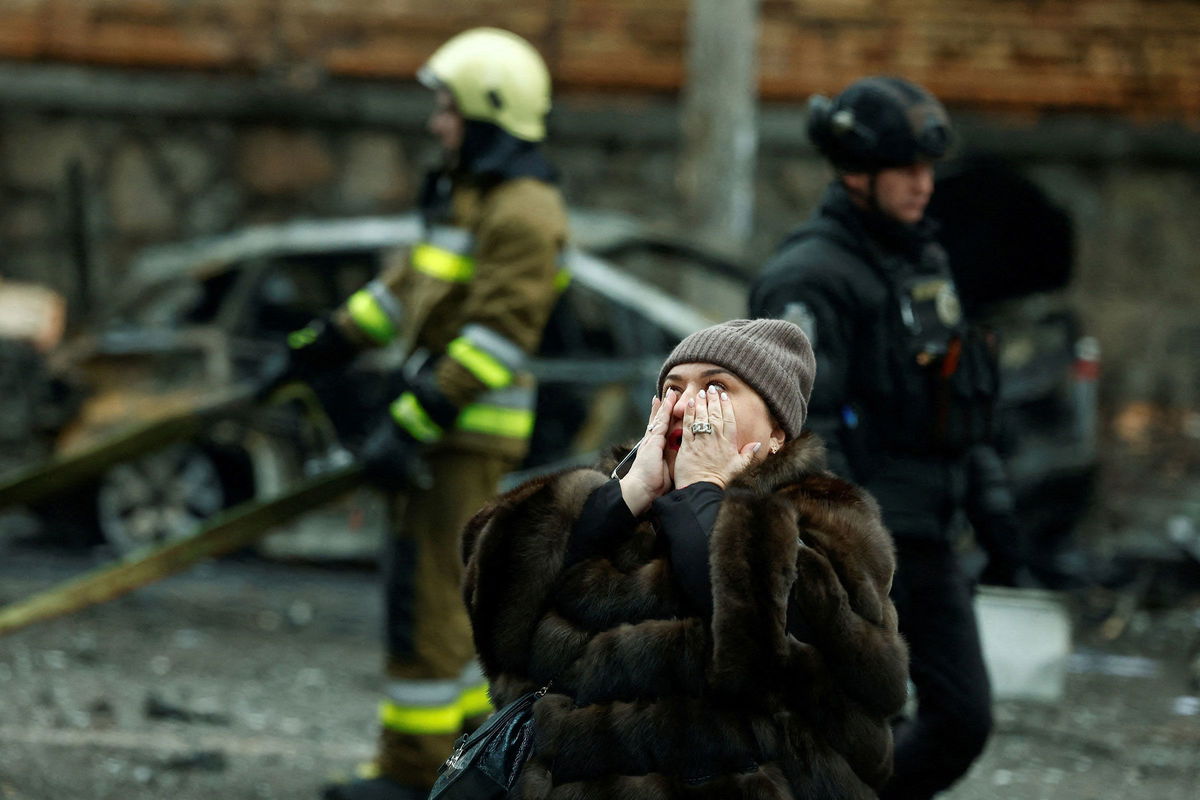 <i>Thomas Peter/Reuters via CNN Newsource</i><br/>A woman reacts at the scene of missile damage.