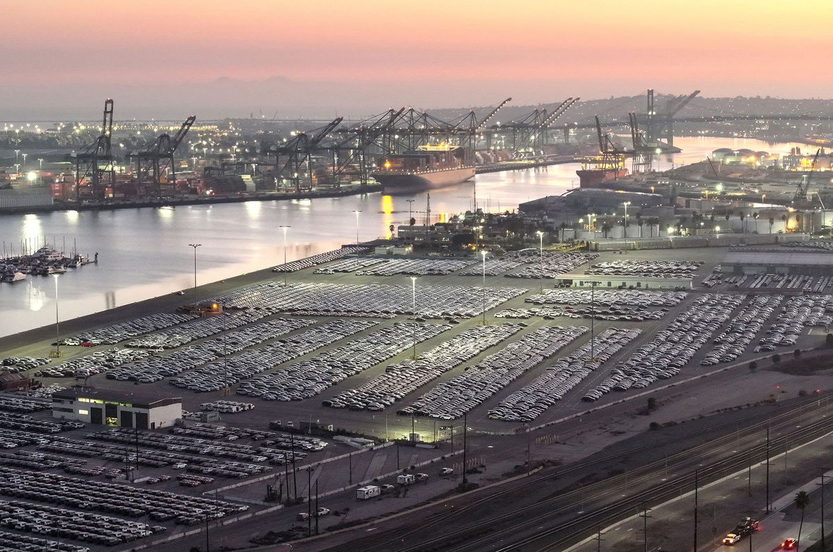 <i>Mario Tama/Getty Images via CNN Newsource</i><br/>An aerial view of newly imported cars parked at the automobile terminal at the Port of Los Angeles in Wilmington