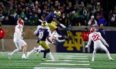 Notre Dame Fighting Irish running back Jeremiyah Love jumps over Indiana Hoosiers defensive back Amare Ferrell.