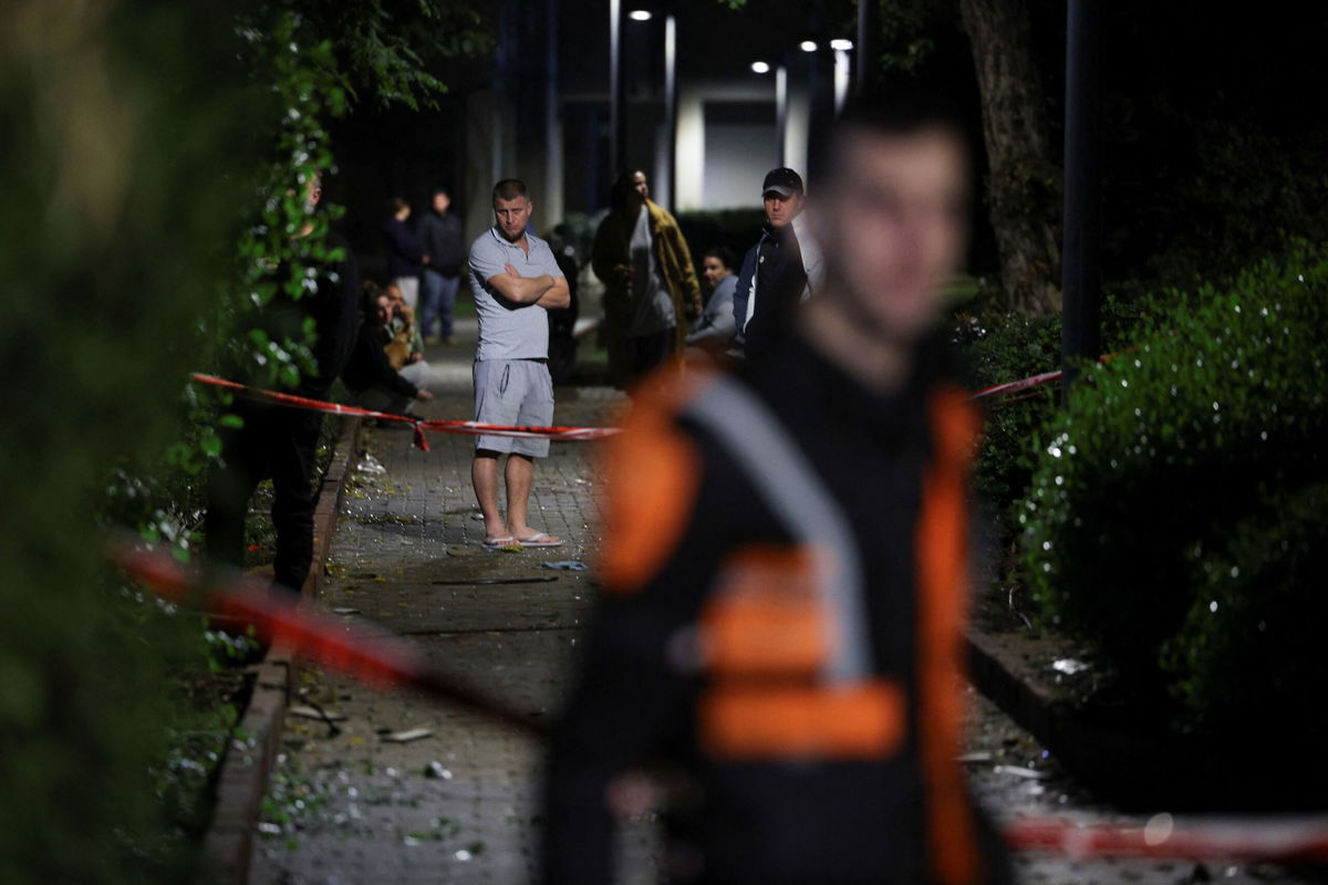 <i>Stoyan Nenov/Reuters via CNN Newsource</i><br/>People gather at the scene of a missile strike that