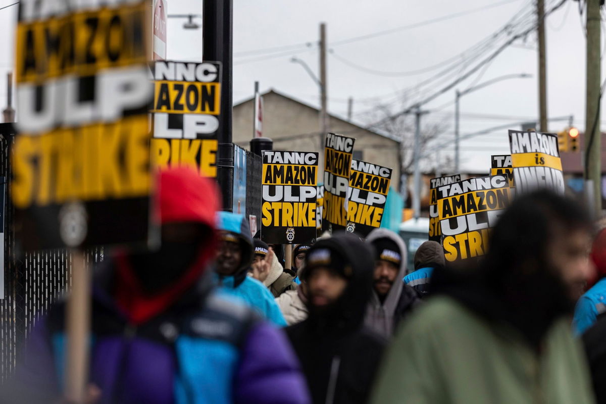 <i>Stefan Jeremiah/AP via CNN Newsource</i><br/>Amazon workers and members of the International Brotherhood of Teamsters picket in front of the Amazon fulfilment center in the Queens borough of New York