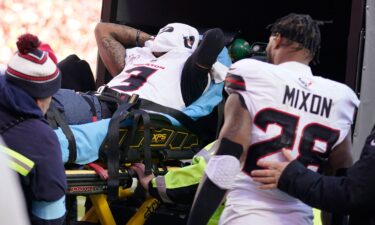 Houston Texans wide receiver Tank Dell covers his face as he is taken off the field on a stretcher after being injured.