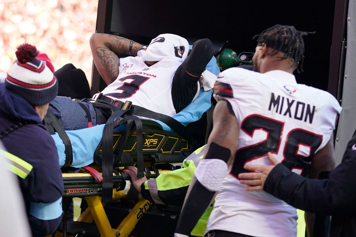 <i>Ed Zurga/AP via CNN Newsource</i><br/>Houston Texans wide receiver Tank Dell covers his face as he is taken off the field on a stretcher after being injured.