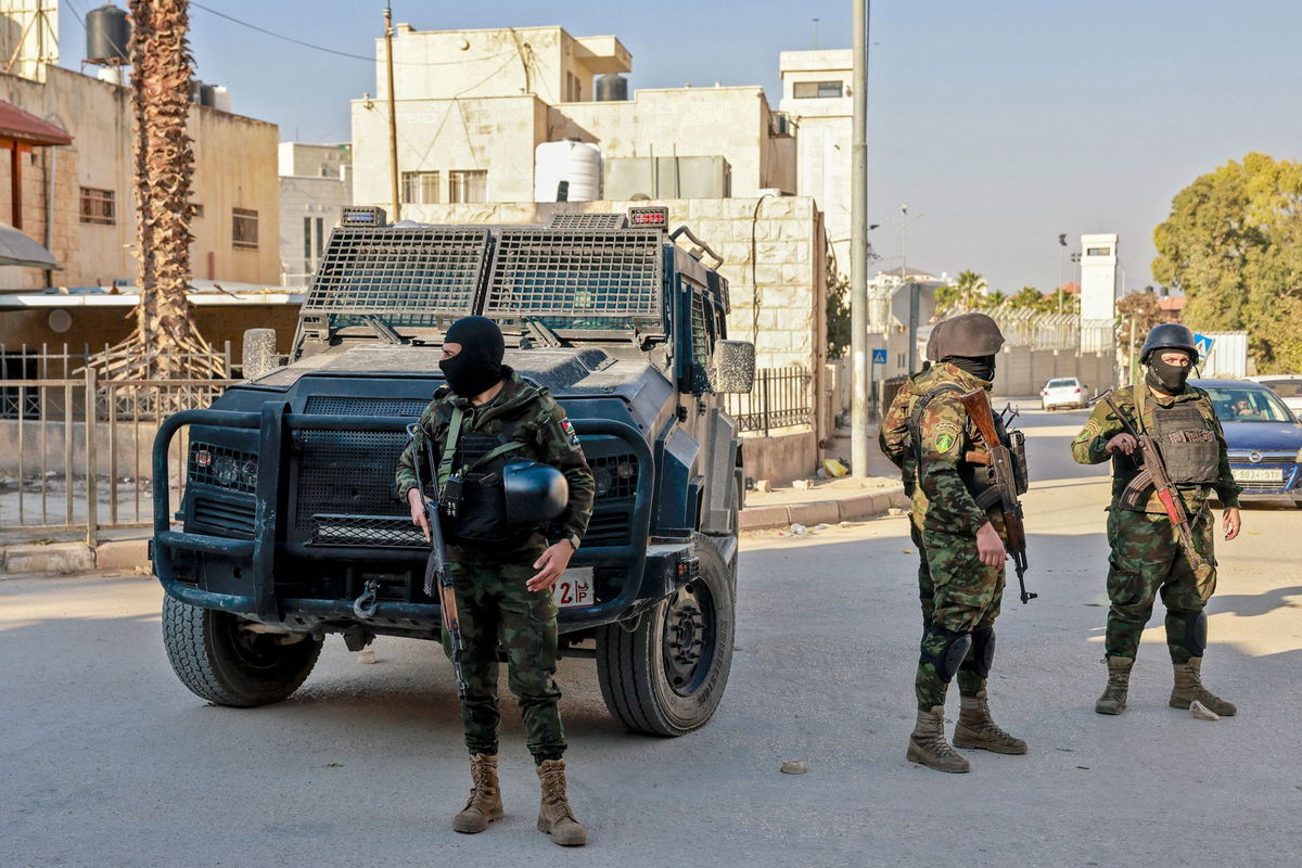 <i>Jaafar Ashtiyeh/AFP/Getty Images via CNN Newsource</i><br/>Palestinian security forces stand guard at a roadblock in Jenin following clashes with militants the day before.