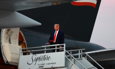 Donald Trump boards Trump Force One as he departs Atlanta Hartsfield-Jackson International Airport after being booked at the Fulton County jail on August 24