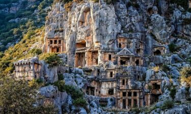 A cascade of rock-cut tombs sits above the ancient city of Myra.