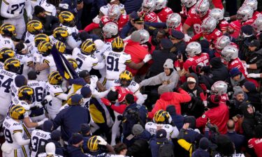 Michigan Wolverines and Ohio State Buckeyes players fight following their NCAA football game at Ohio Stadium.